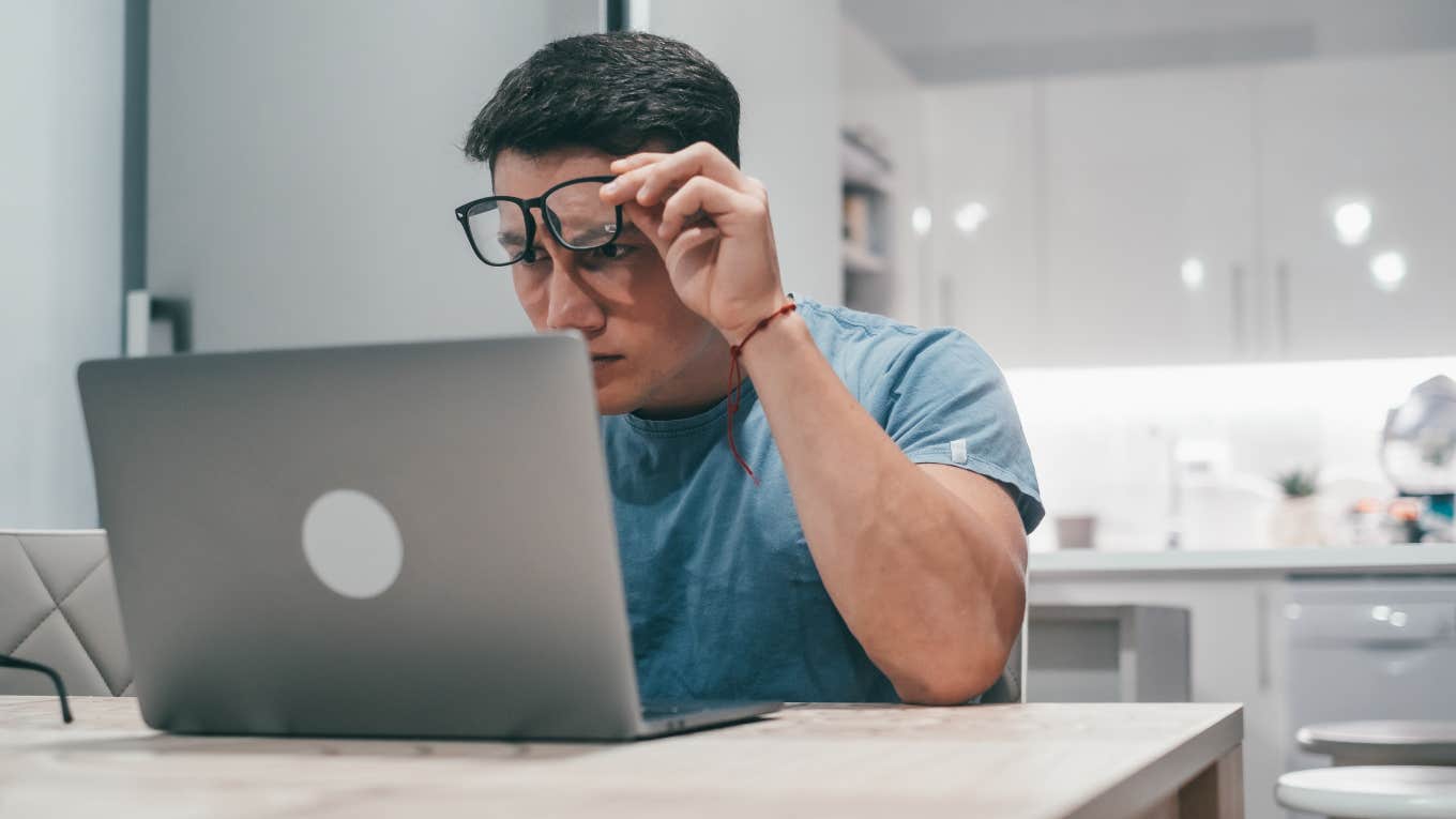 man looking at computer in confusion