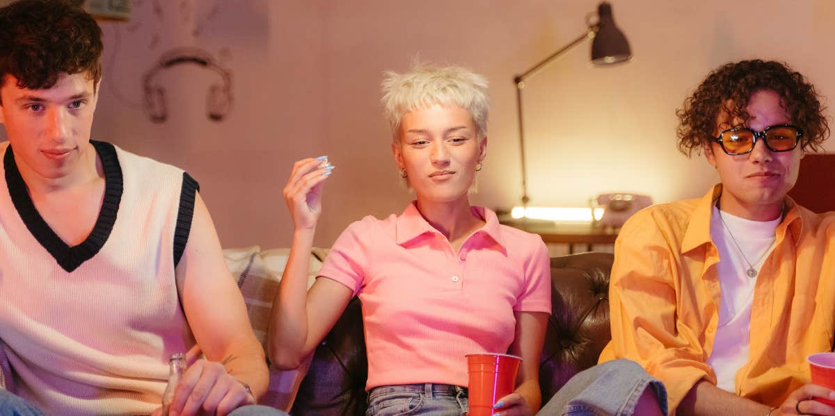 three people sitting on a couch