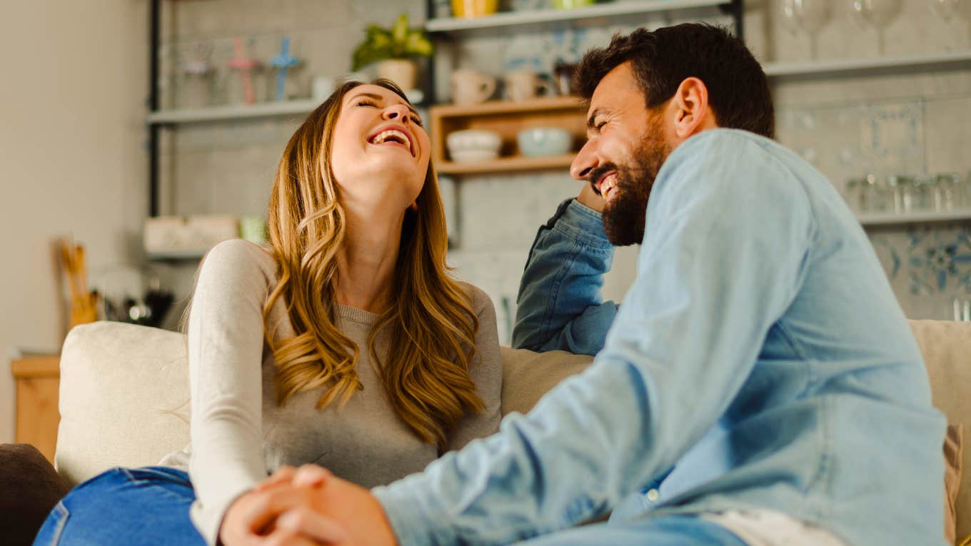 happy couple sitting on couch