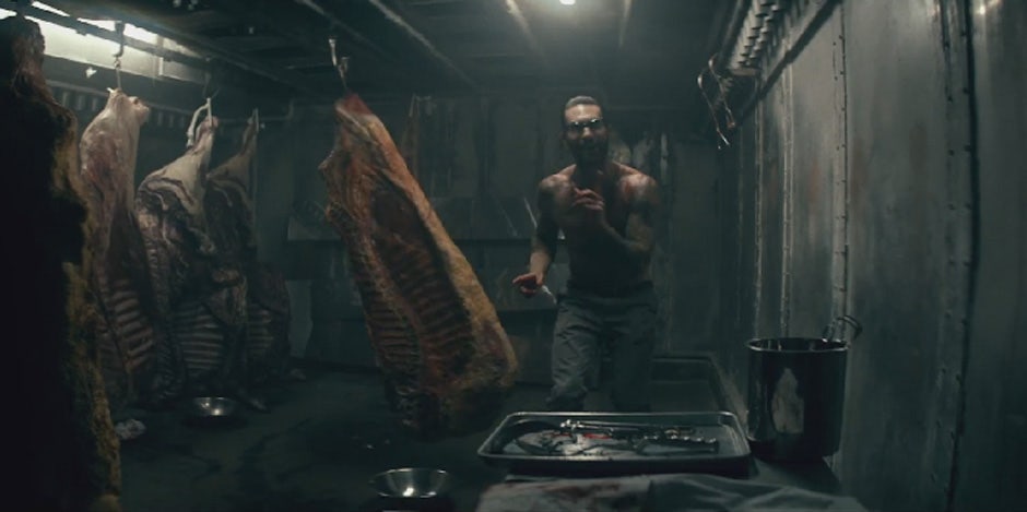 Adam Levine with meat in the Maroon 5 "Animals" video