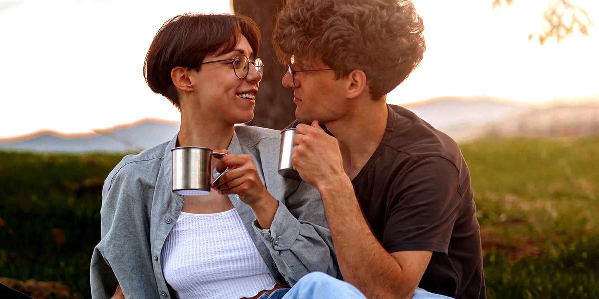 couple having drinks together while camping