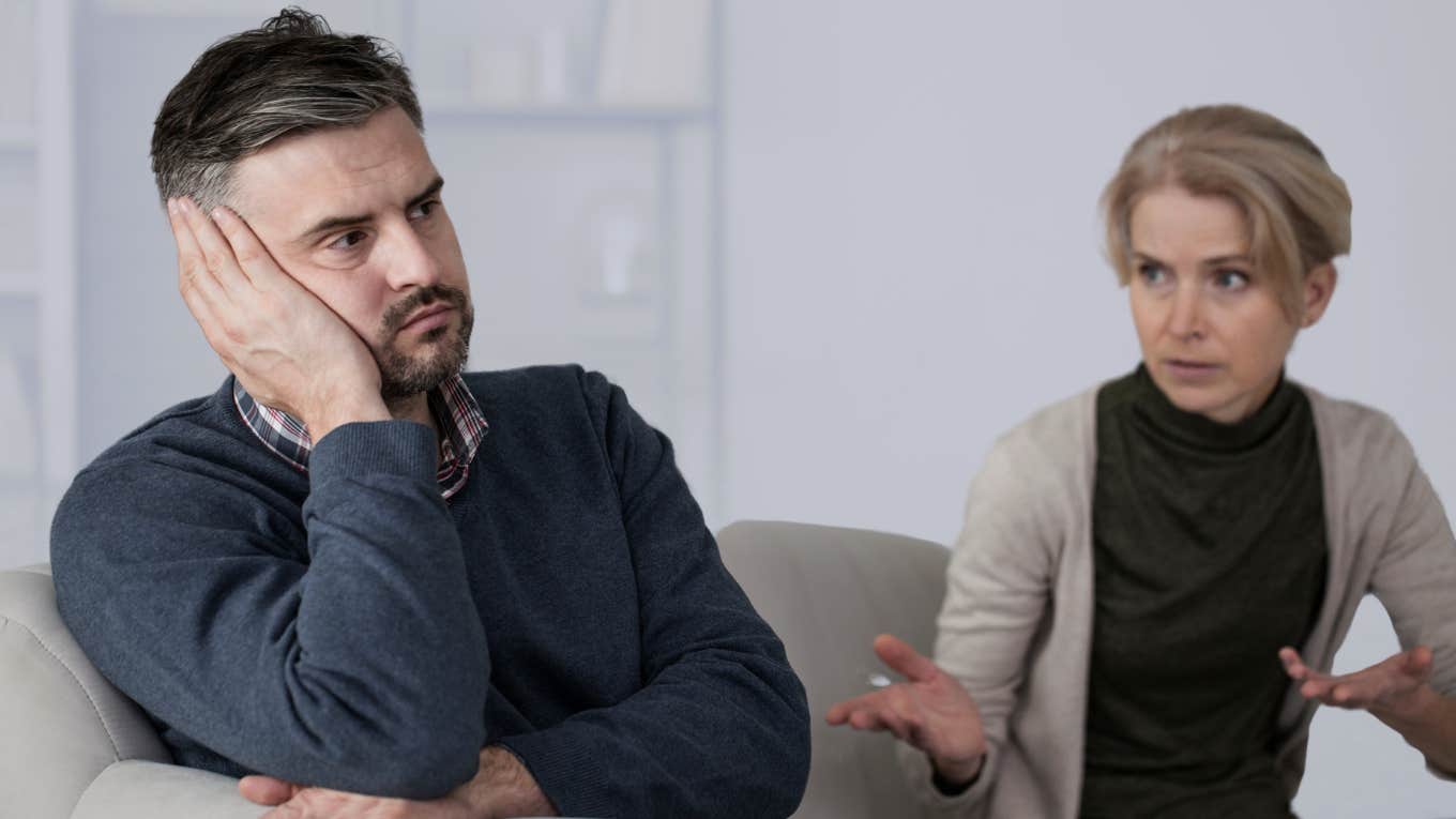 Husband looks upset while his wife argues with him. 