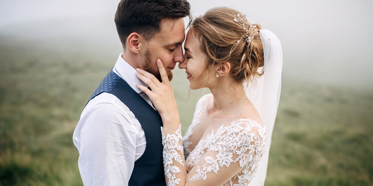 man and woman embracing faces on wedding day