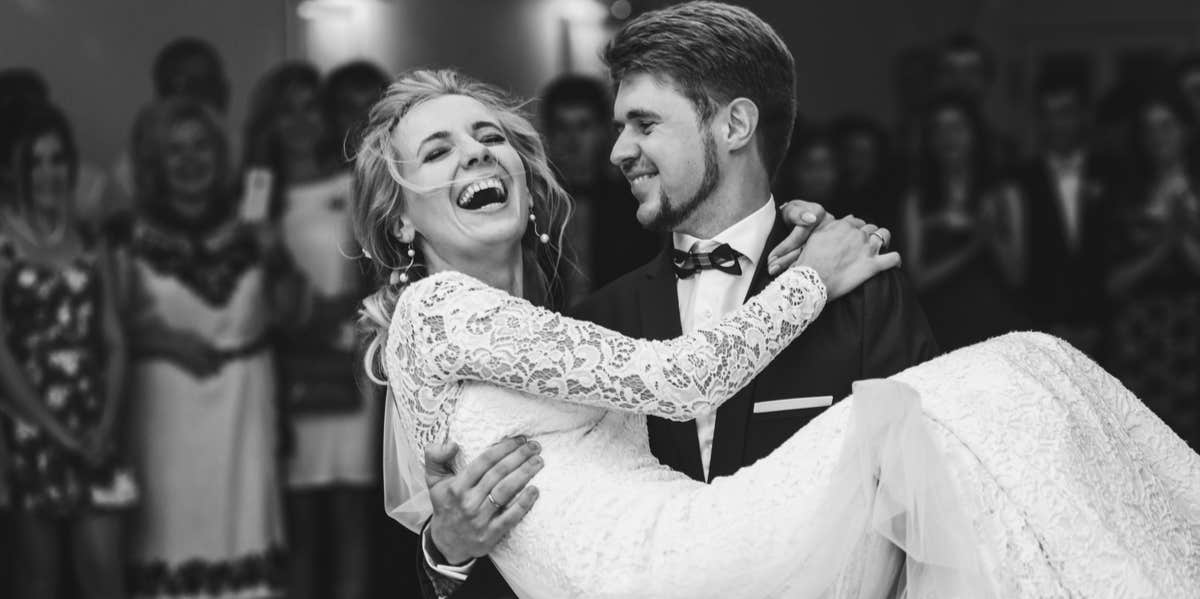 groom carrying bride at wedding