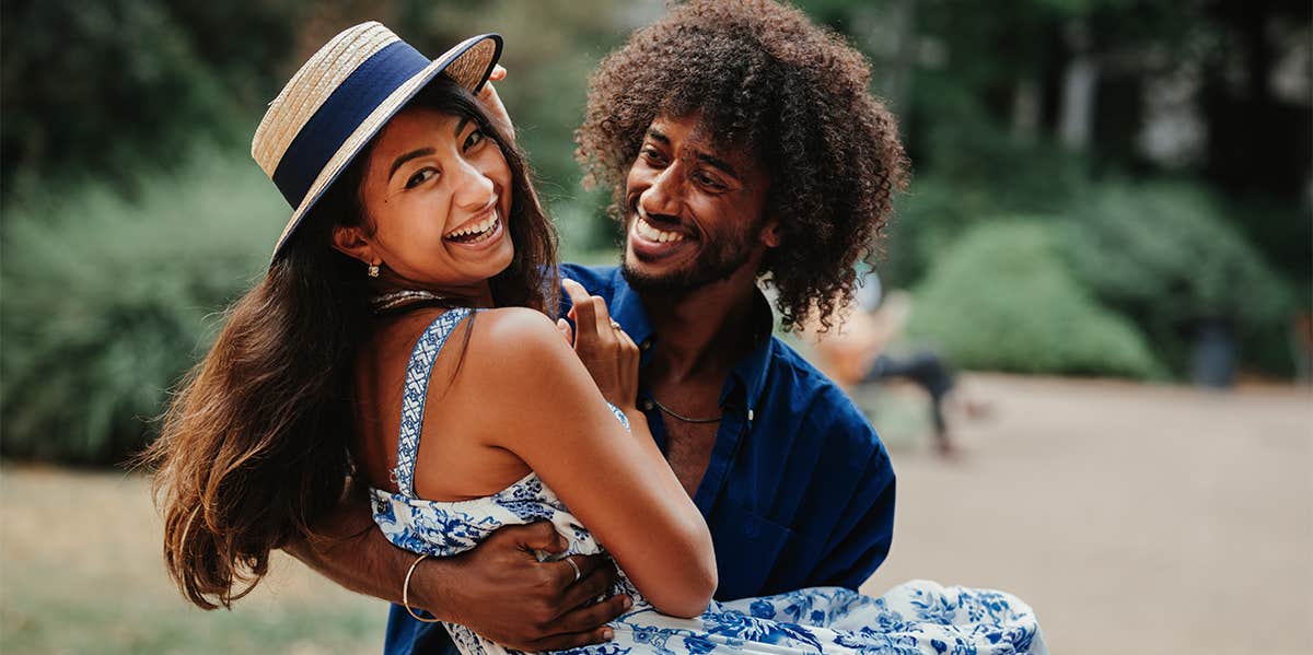 smiling couple man carrying woman