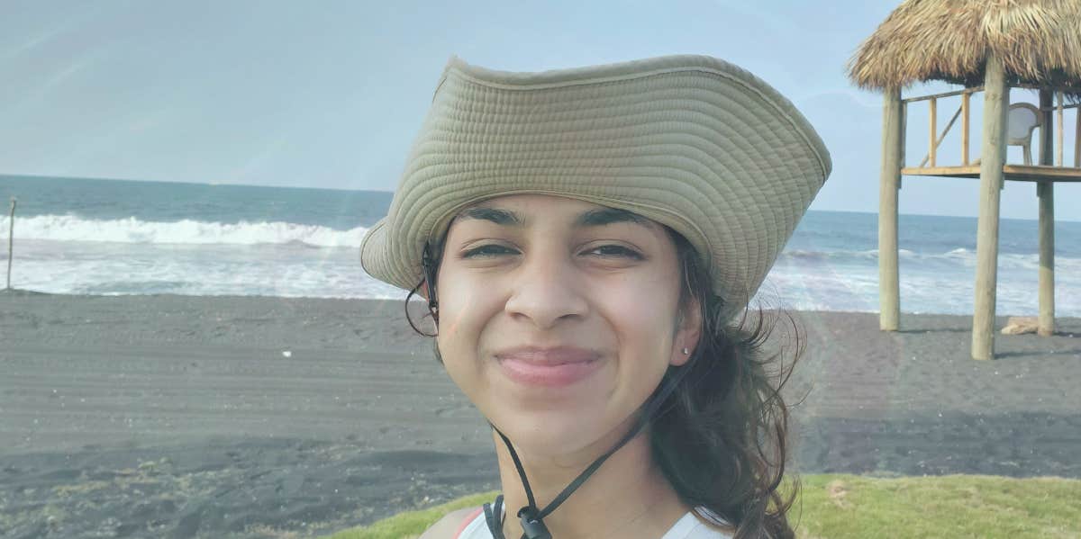 woman in hat at the beach