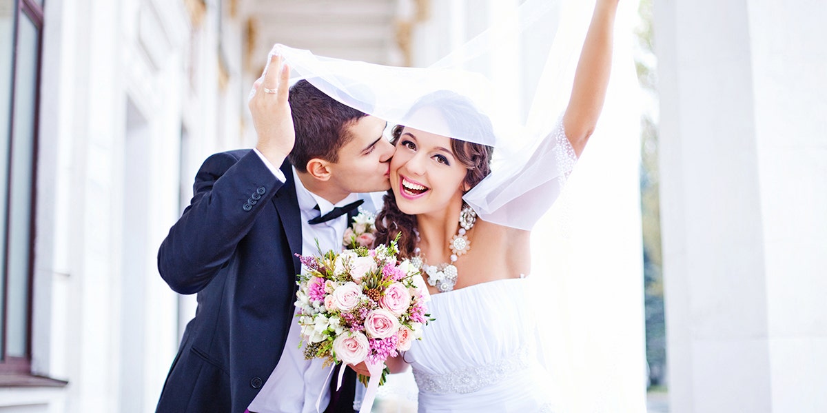 The Only Reason We Married Was For Health Insurance bride and groom celebrating after tying the knot