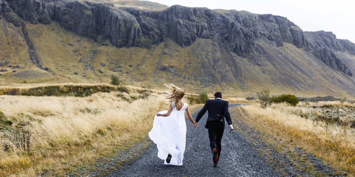 bride and groom holding hands