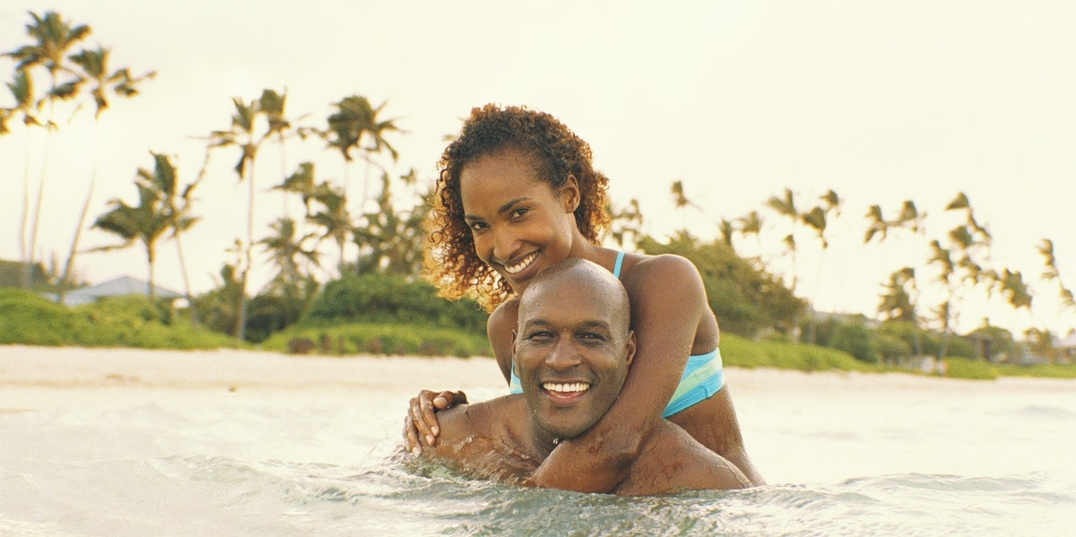 man and woman swimming in the ocean