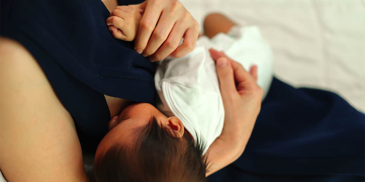 Mom Breastfeeds Her Baby While Being Intimate With Her Husband mom feeding baby