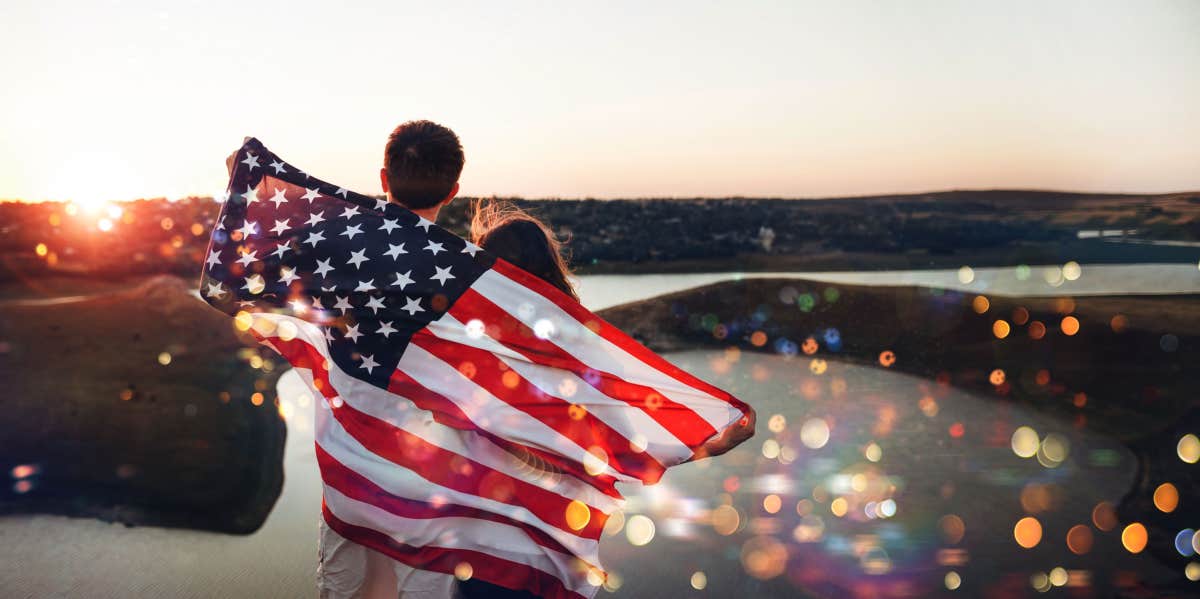 couple standing with American flag