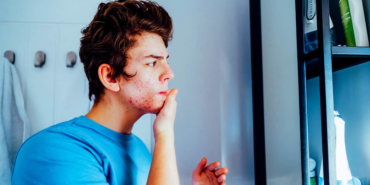 man doing skincare in mirror