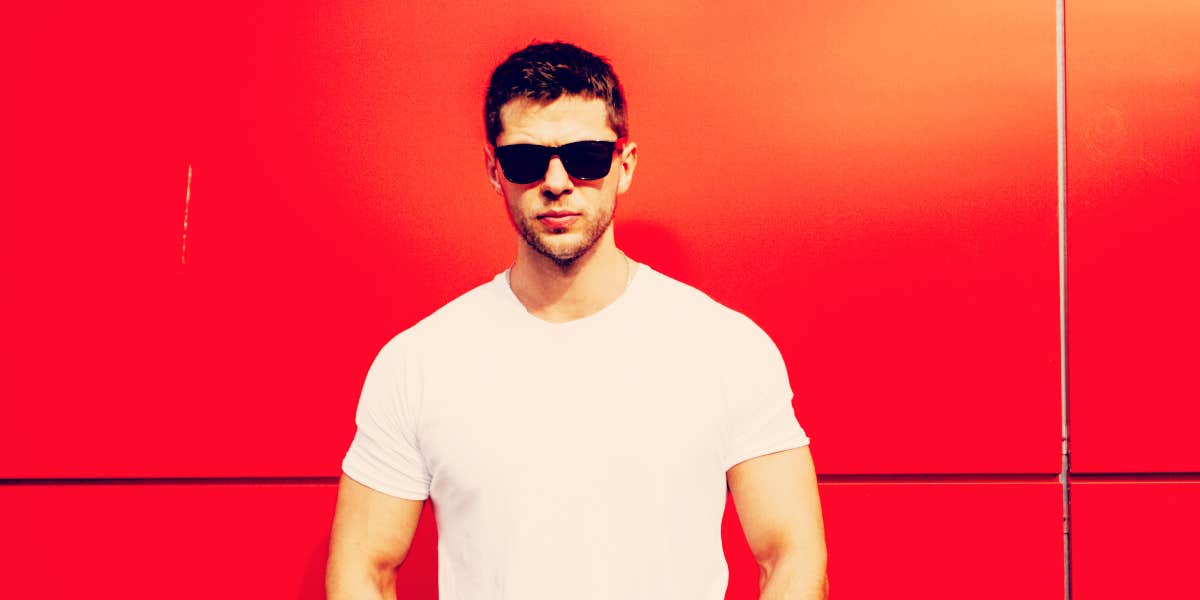 How men set themselves up for failure man in sunglasses standing in front of a red-orange wall