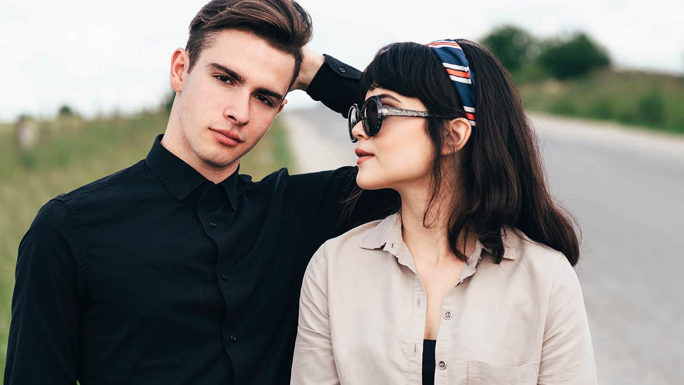 man and woman having a disagreement on the side of the road