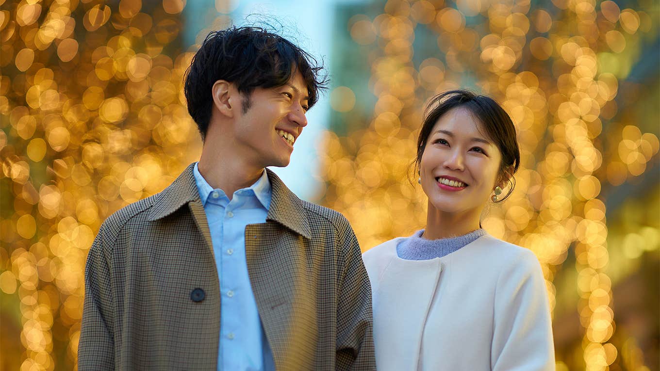 happy couple walking under lights