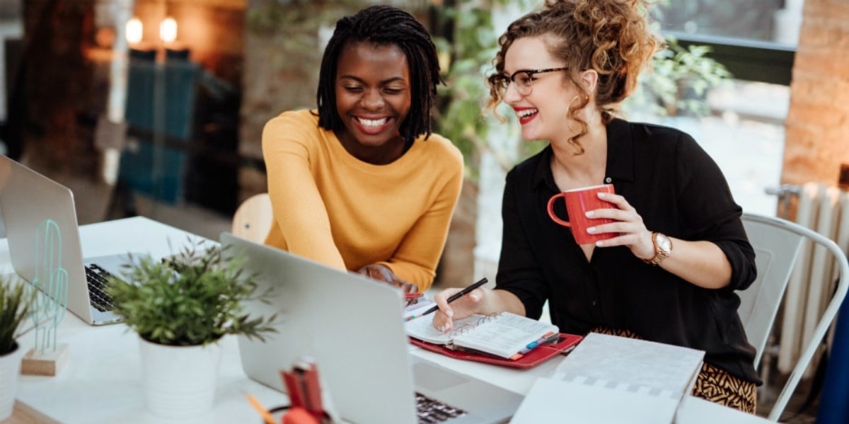 two women working in front of computer