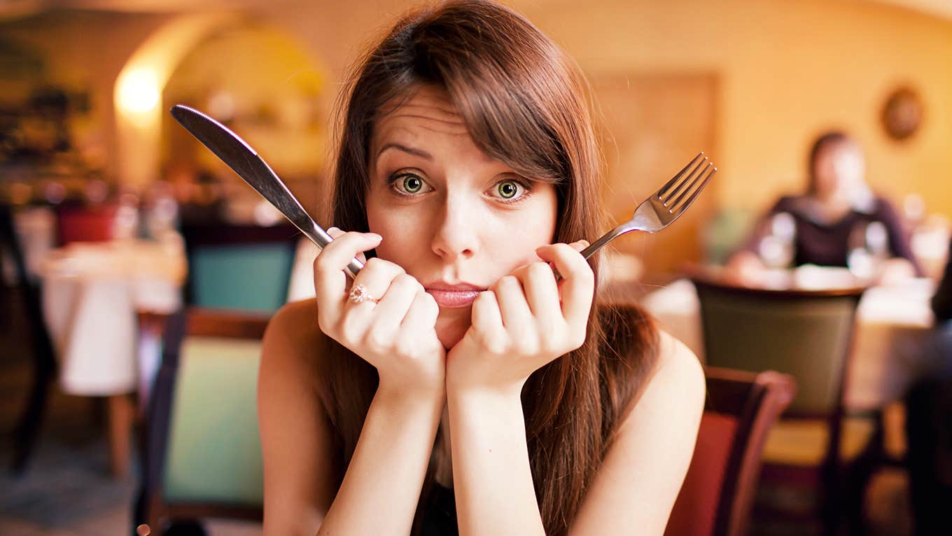 What It's Like To Have A Messed Up Relationship With Food woman holding fork and knife