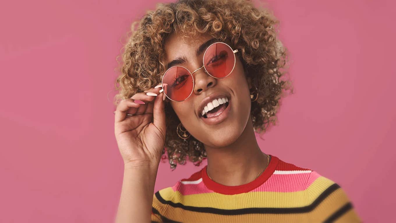 woman with rose colored glasses smiling