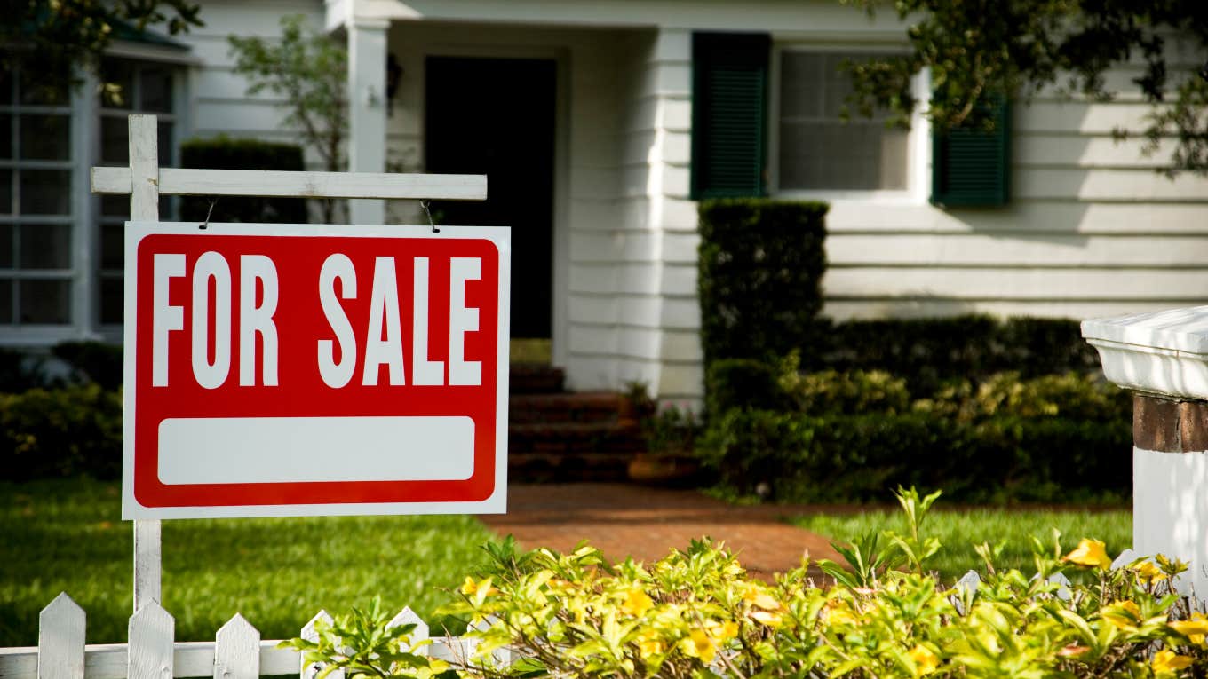 for sale sign in front of house