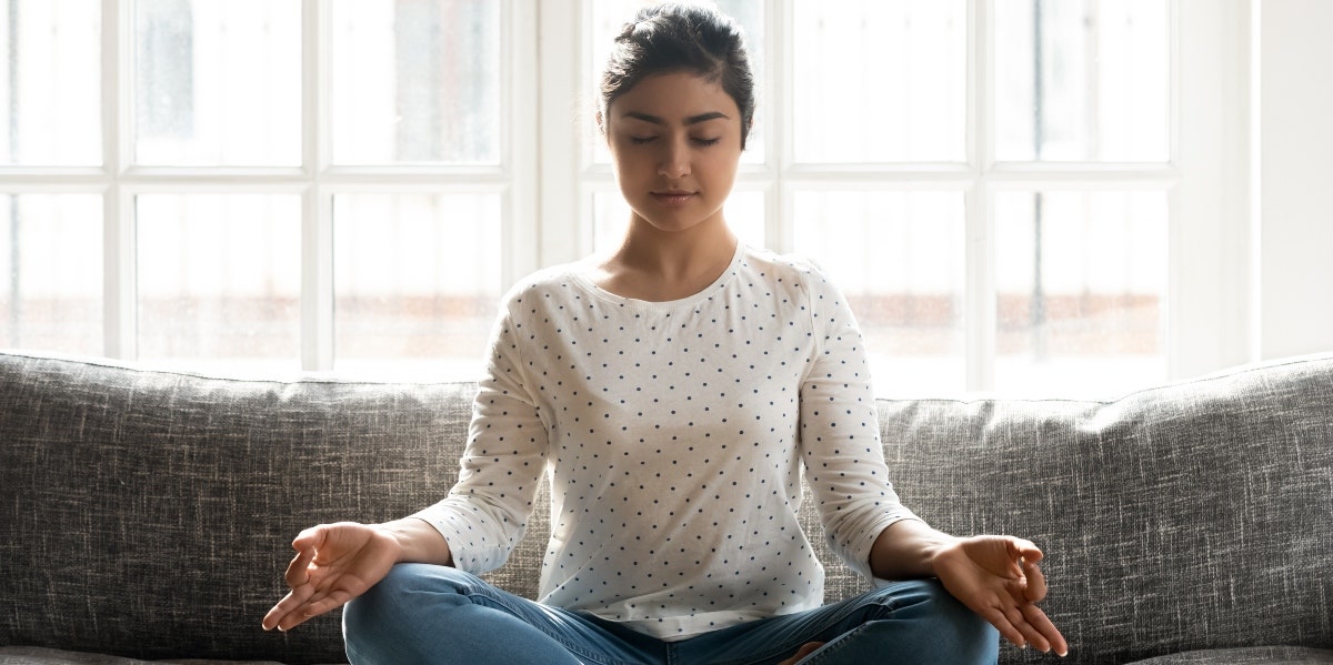 mindfulness and stress woman meditating on couch