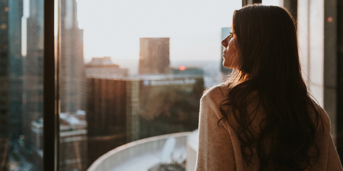 woman looking out window