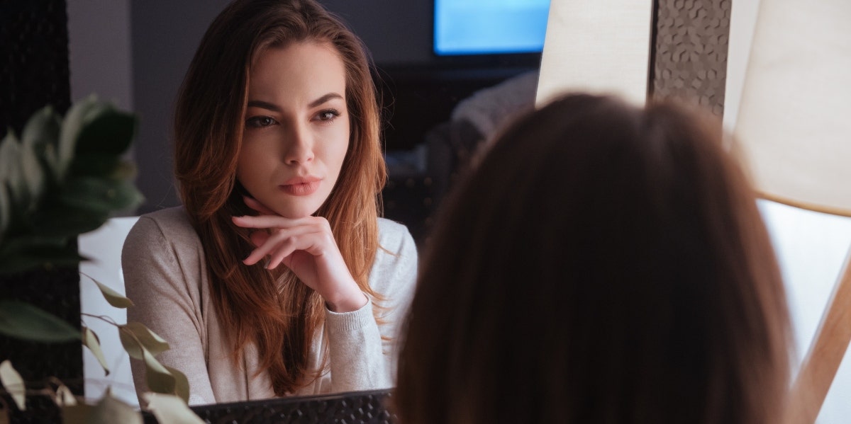 woman looking in the mirror