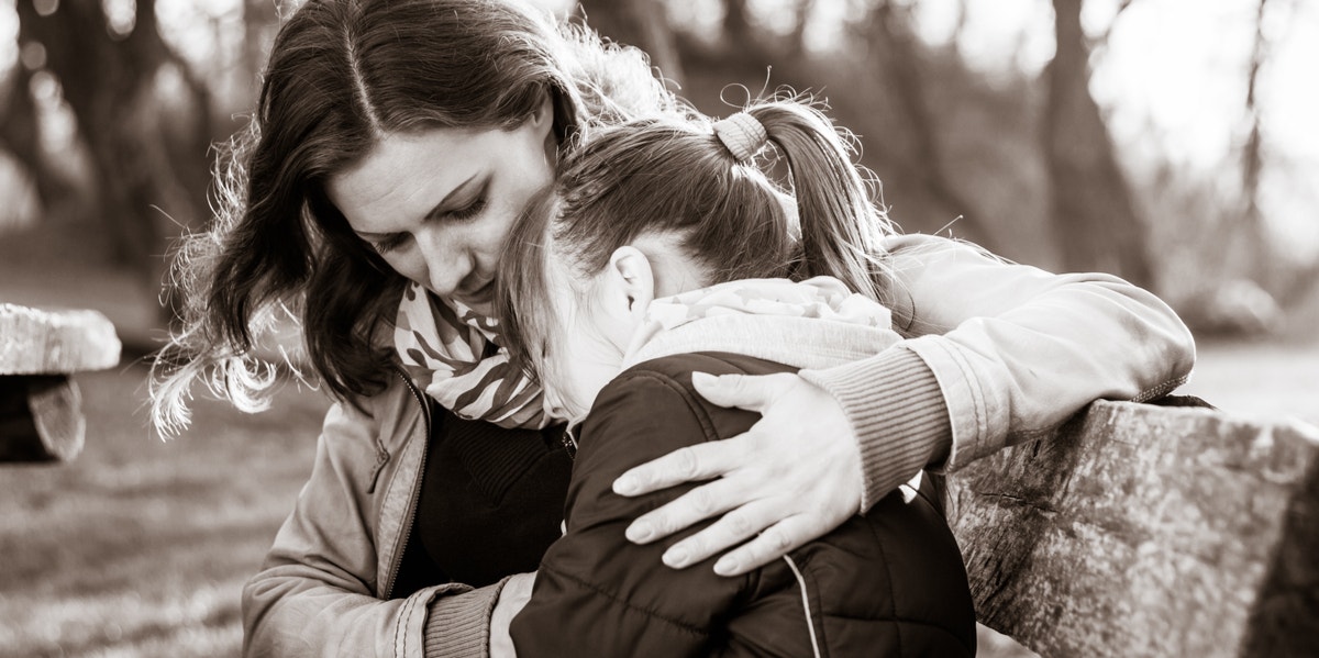 mom comforting daughter