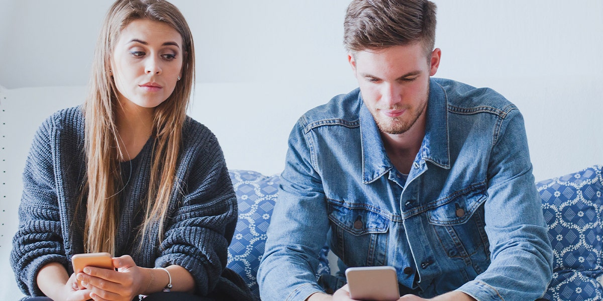 Modern Dating Is Destroying Relationships — A Former Player Explains Why woman and man sitting together on couch looking blankly