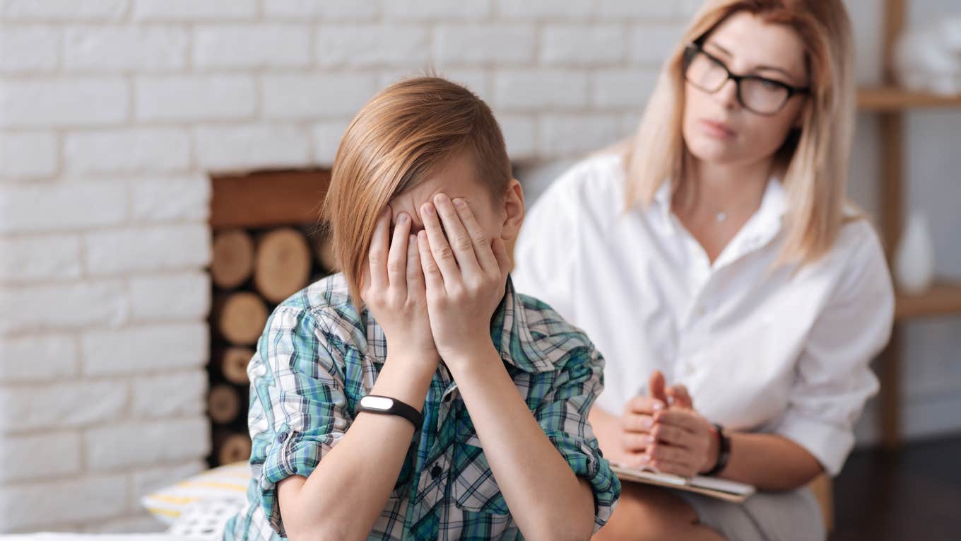 Child looking upset in front of mother. 