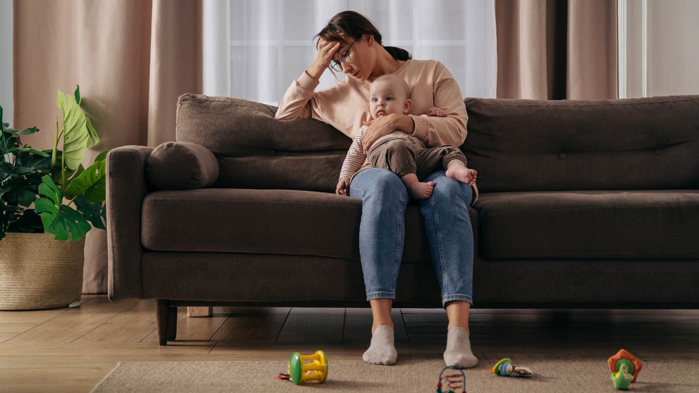 Mom Admits That Motherhood Sucks And She Hates It overwhelmed mother holding a baby