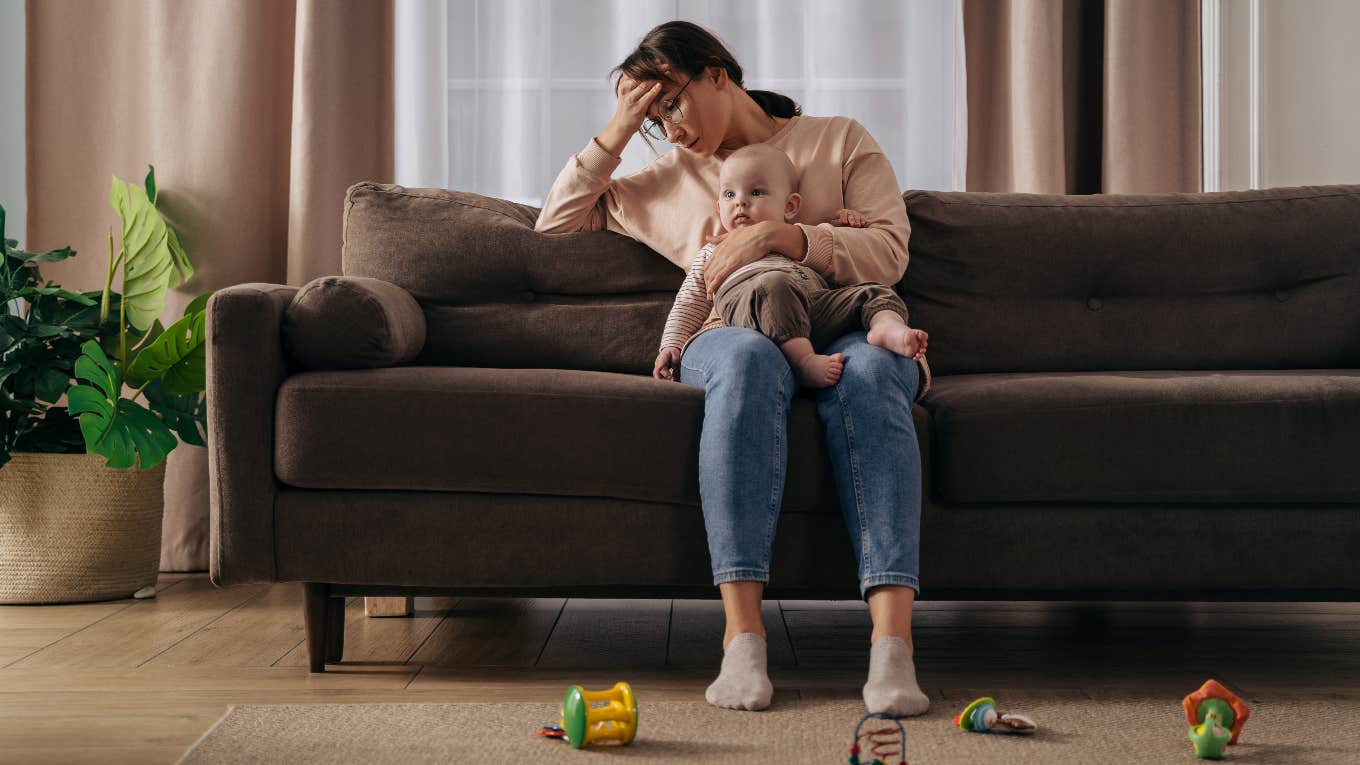 overwhelmed mother holding a baby