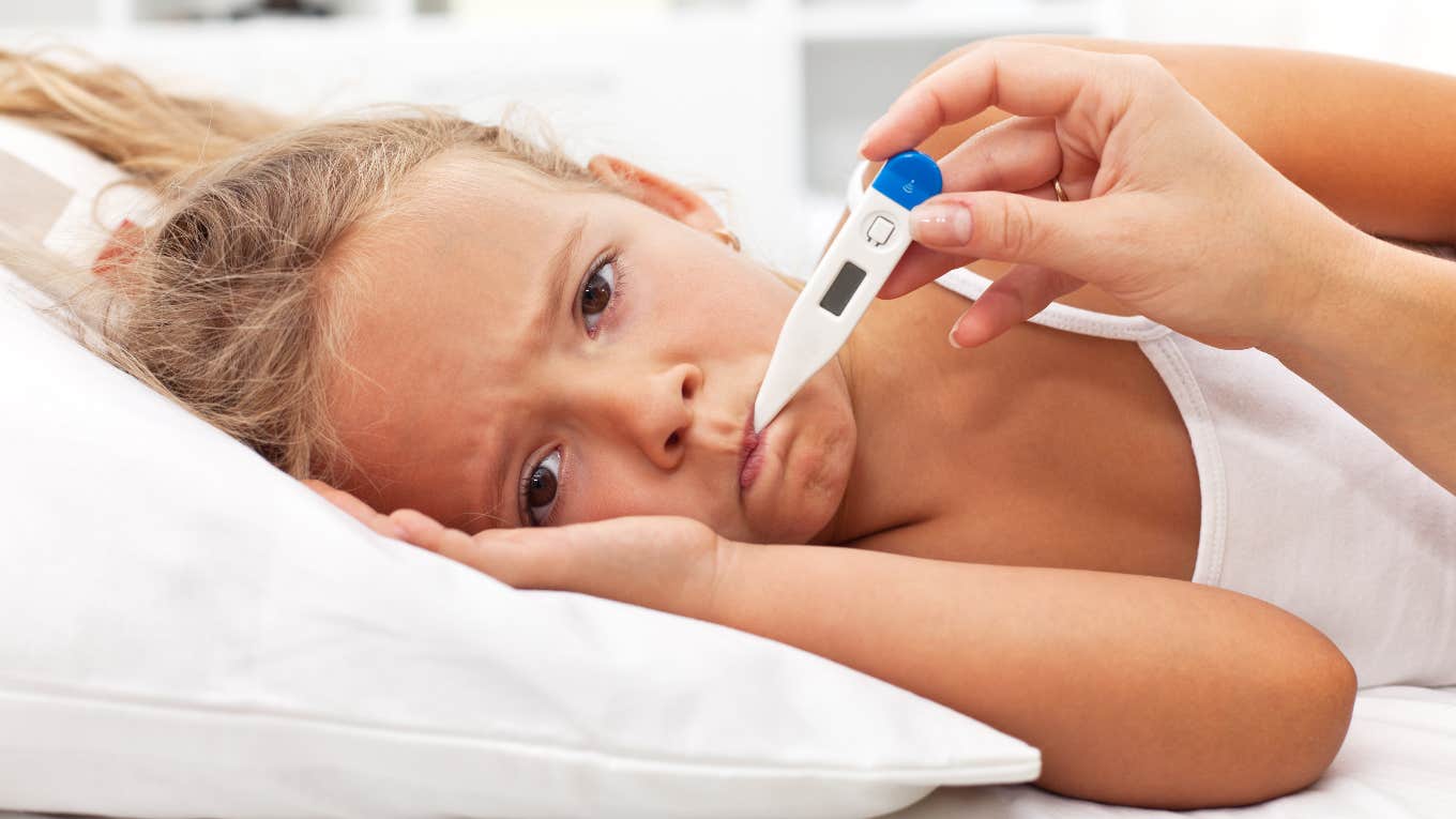 sick girl with thermometer