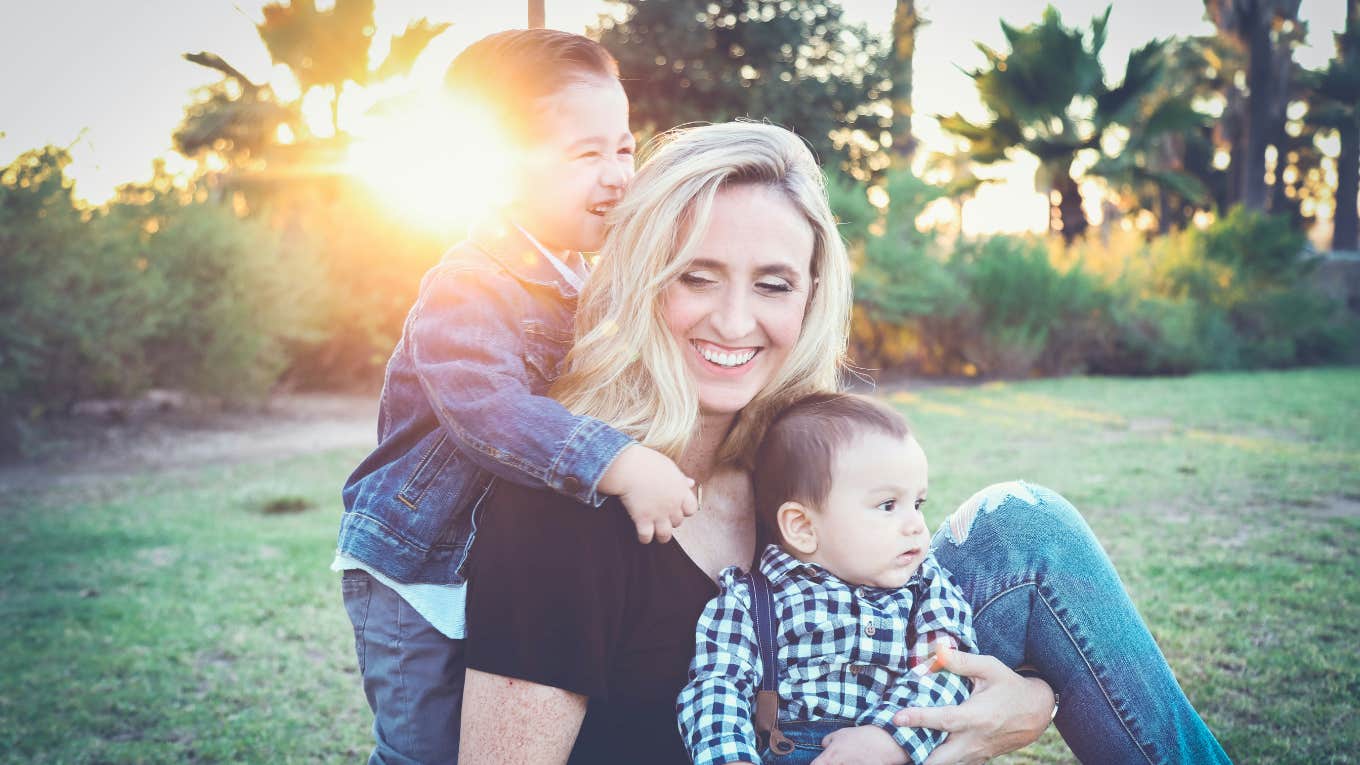 mom with kids in a yard 