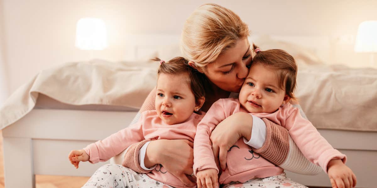 Woman holding twin babies