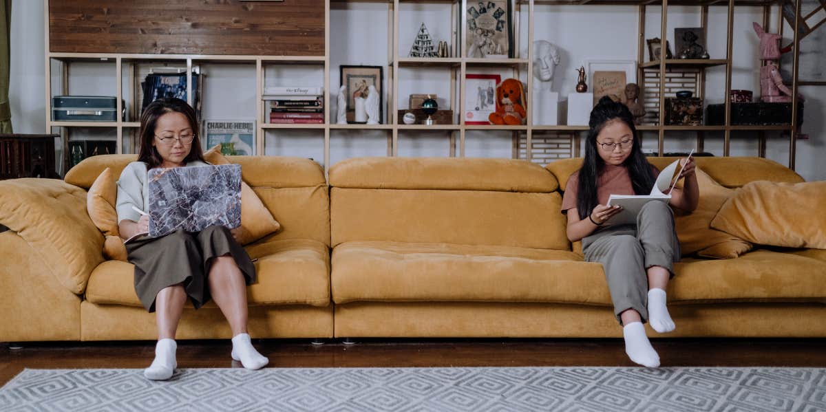 Mom and daughter on a couch reading