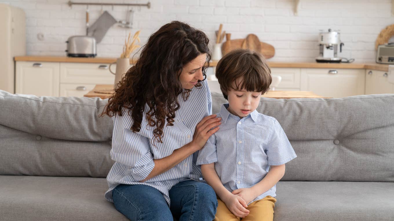 Worried mom talks to frustrated little boy after fight