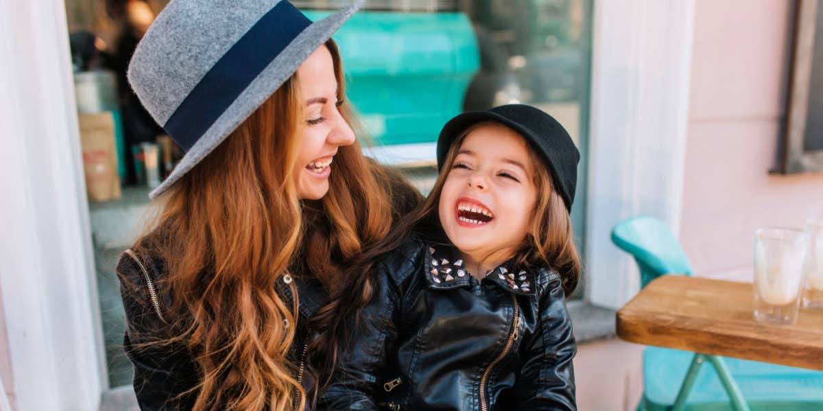 A mom and her daughter laughing