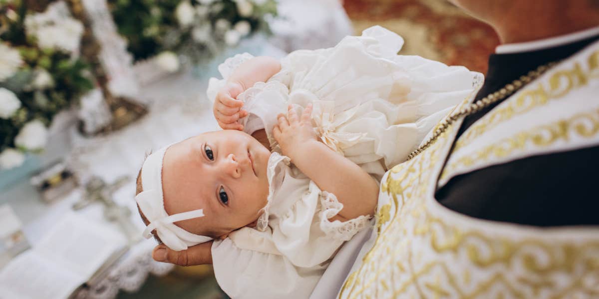 Mom Asks If She's Wrong For Not Inviting Family To Baby's Baptism So No One Can Post Photos Of Her On Social Media baby wearing baptism dress