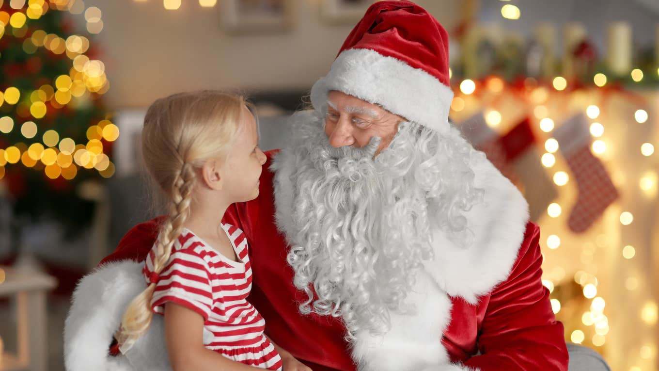 Little girl sitting on Santa's lap