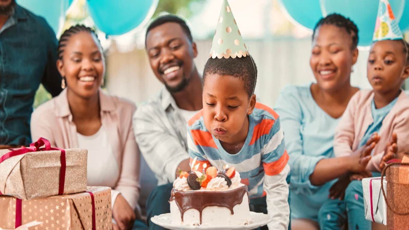 boy blowing out birthday candles