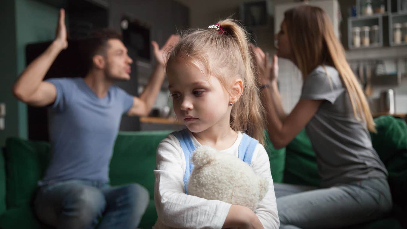 parents arguing in front of young girl