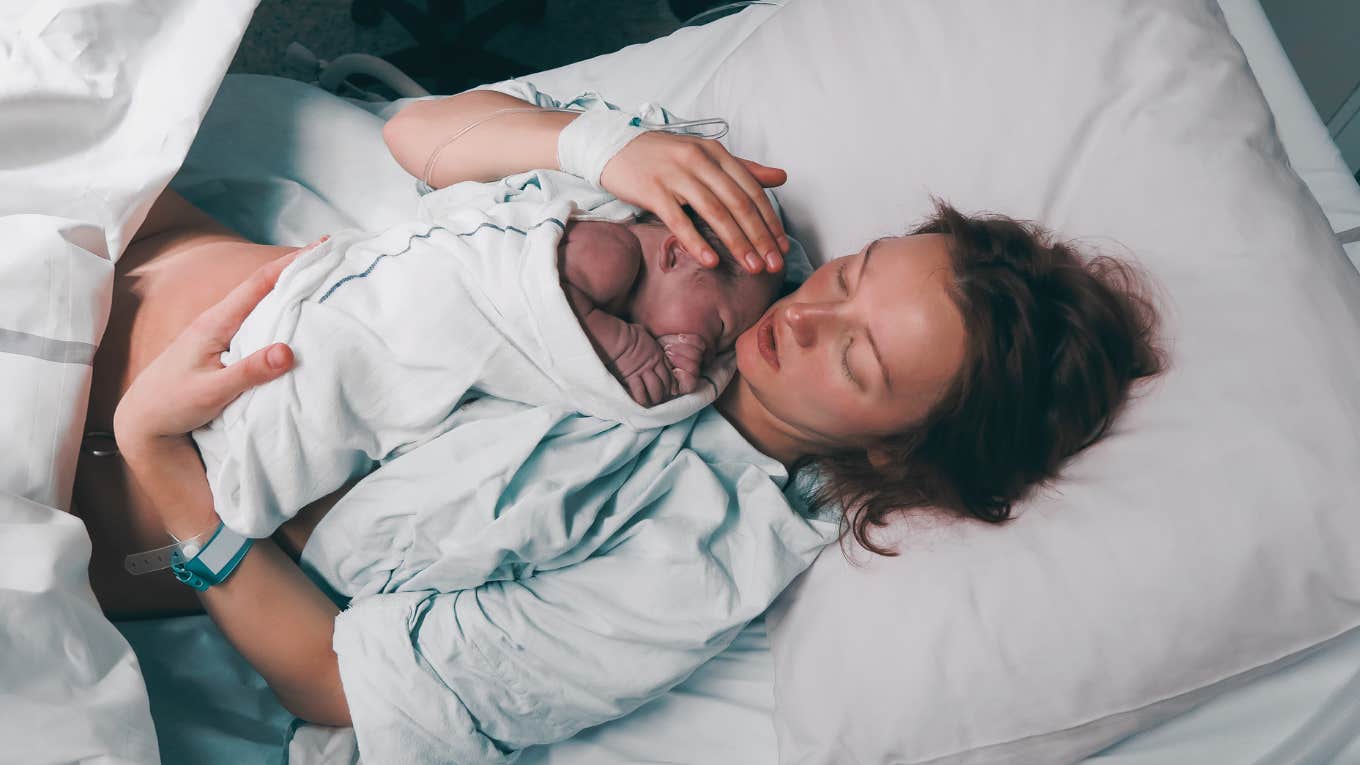 Mother holding her newborn baby child after labor in a hospital