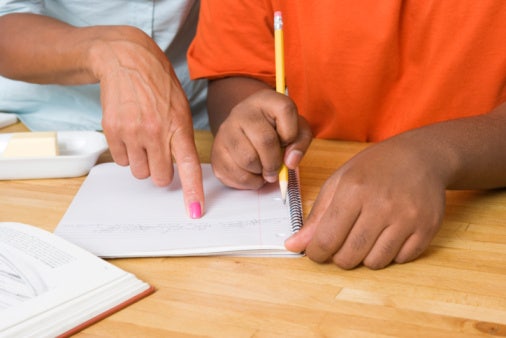 mother helping child with homework