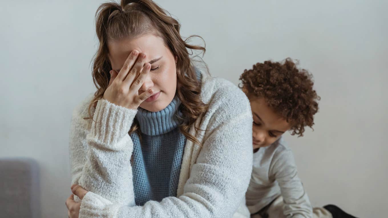 Mom Hides From Her Kids Who Won't Leave Her Alone Mom looking frustrated with a young kid