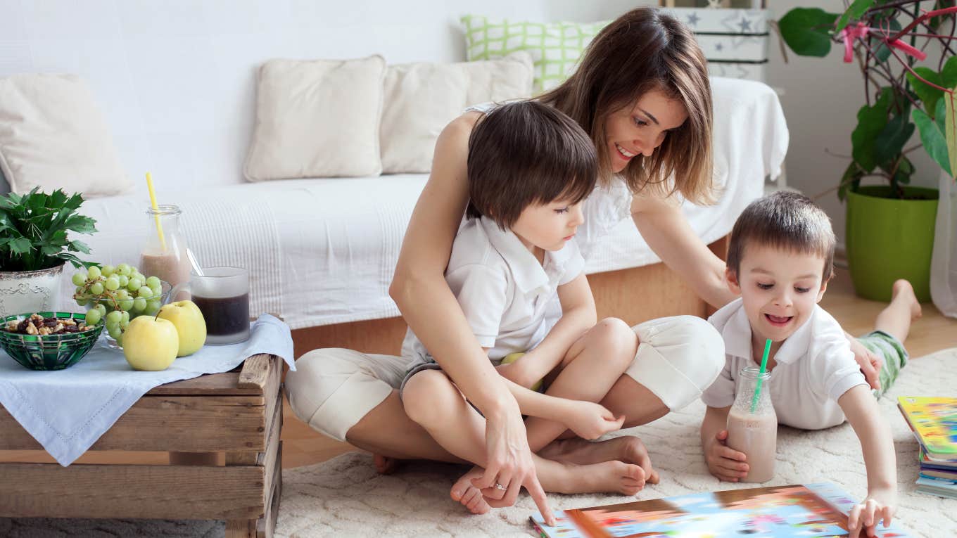 mom playing on the floor with two sons