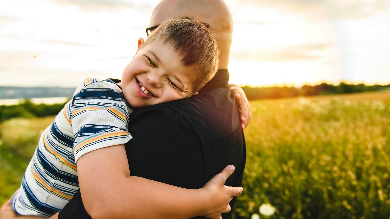 little boy hugging his father