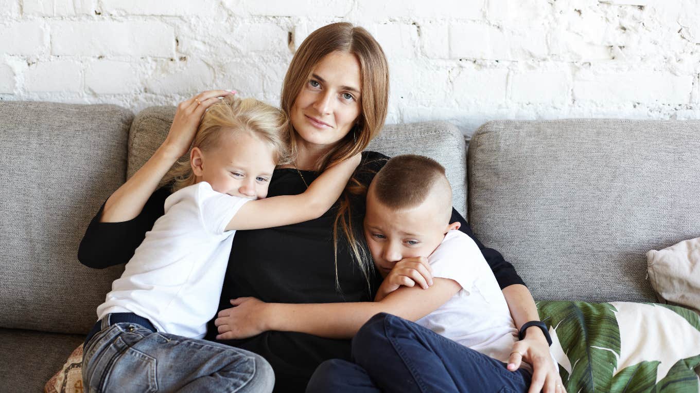 Mom Raising Her Boys To Be Obsessed With Her So They Never Spend Holidays With Their Future In-Laws mom hugging two young boys on couch