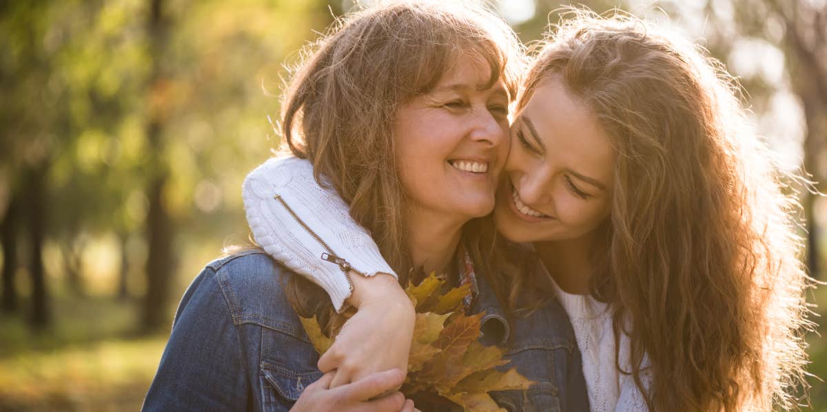 Mom Refuses To Let Daughter Move In After Her Landlord Raised Her Rent — Says She Needs To 'Take Care Of Herself' Mother and daughter embracing while holding leaves