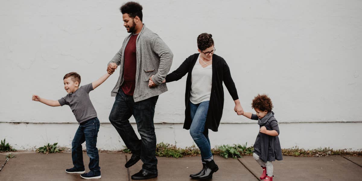 Mom Says The Hardest Part Of Carrying Mental Load In Her Family Can Be Explained By How School Performances Are Handled In Her Home family walking together in a line