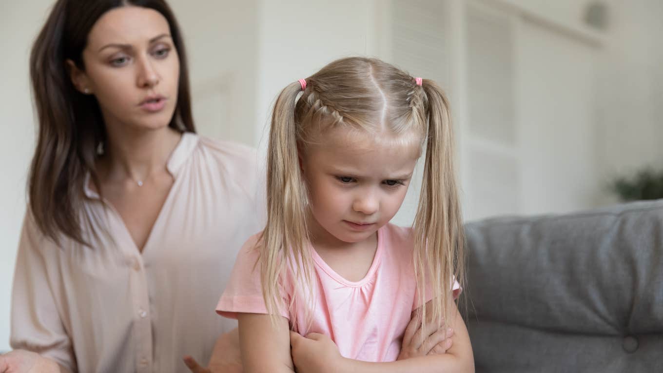 mom talking to crying little girl